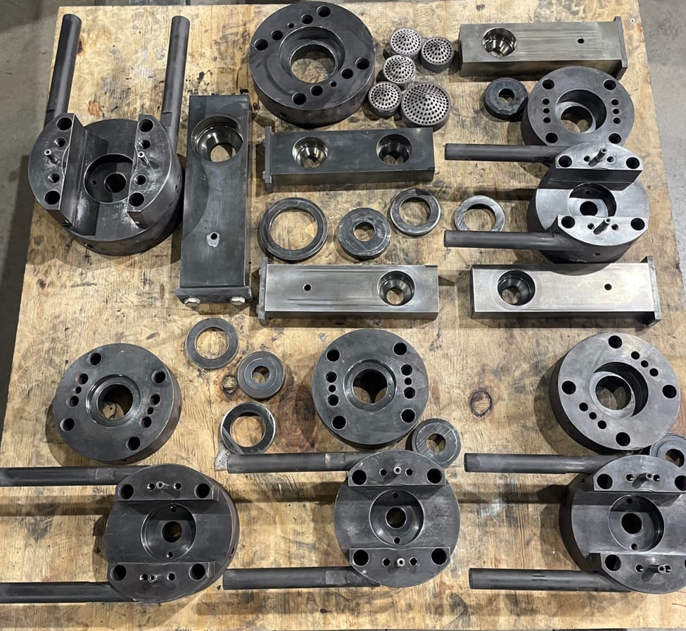 Photo of metal items on a work table.